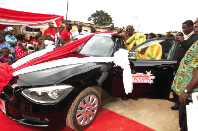 Nana Ofori Ansah (in cloth) by his prize car after the presentation. 