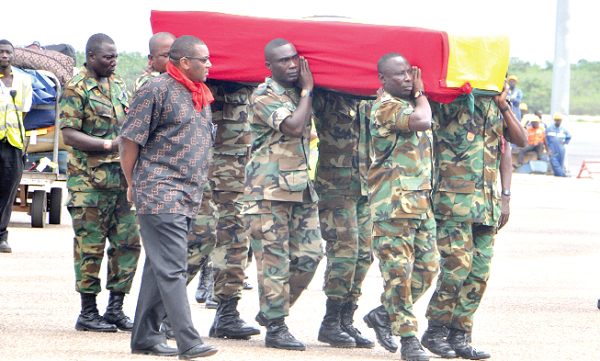 Military personnel carrying the casket containing the mortal remains of Professor Kofi Awoonor at the airport. Pictures: GABRIEL AHIABOR