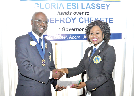 Lion Gloria Esi Lassey (right)handing over documents to Lion Godefroy Chekete