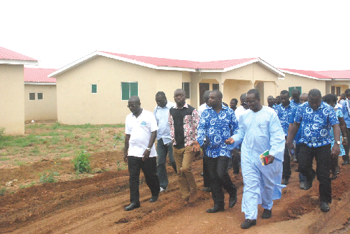 Mr Eric Ebo Acquah (middle), CEO, Blue Rose Limited, explaining a point to Mr. Sampson Ahi (2nd left), the deputy minister of Water Resource Works and Housing, during a tour of the Blue Rose Estate at Budumburam. 
