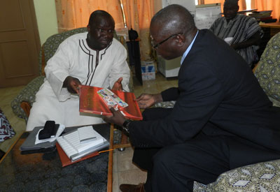 Mr Kenneth Ashigbey, MD of Graphic handing over a souvenir to the Rector of B-Poly, Dr Mba Atinga