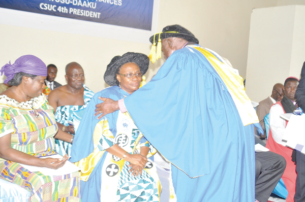 Rt Rev Prof. Osei Sarfo Kantanka (right), Chairman of Council of the College, inducting Prof.  Frances Owusu-Daaku after the decoration of robe. With them include Mrs Joyce Stuber (left), Member of Board of Trustee of the college.