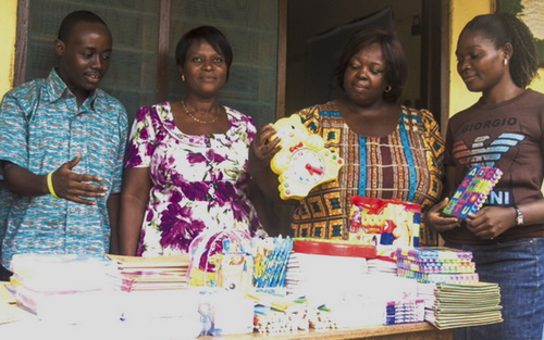 • Mr Bonney (left) describing the items to Mrs Adjei (2nd left) and two other staff of the school.