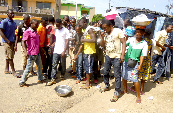 Some residents of Koforidua observing the eclipse from a bowl of water. Picture: Nana Konadu Agyeman