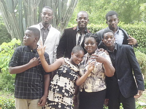 • Mr Eric Ebo Acquah (middle back row) sandwiched by his children,  Jeremiah (right) and Ezekiel (left), while on the front roll from left to right are, David, Susana Maame Sika, his wife, Angela and Frederick Acquah.