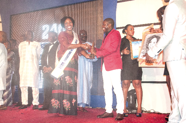 The CEO of Strategic Communication Africa (Stratcomm), Esther Cobbah receiving an award from Mr Roland Agambire, CEO, rLG Communications, for winning the 2012 CIMG Marketing Woman of the Year.