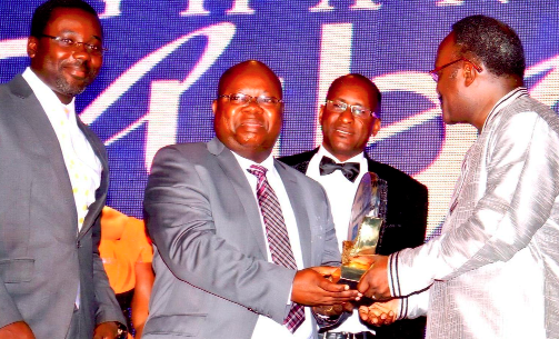 Mr John Kofi Mensah (2nd left) receiving the award from Mr Kwesi Ahoi. With him is Head of Marketing & Corporate Affairs, Nana Yaw Kesse (left). 