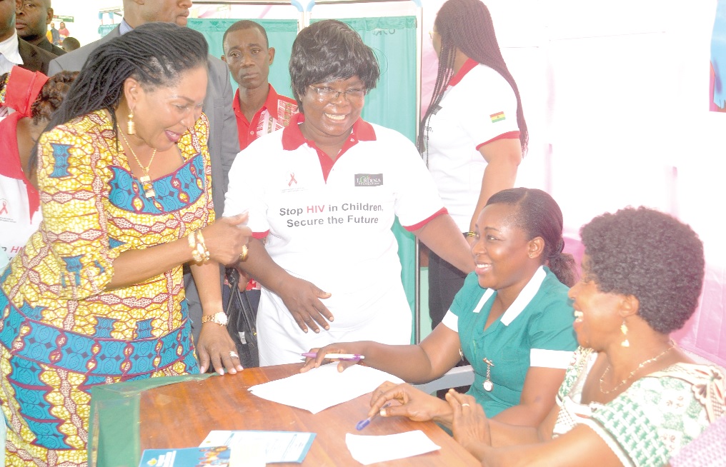 Mrs Lordina Dramani Mahama (left), gives thumps up to the nurses for their good jobs done during the health screening.