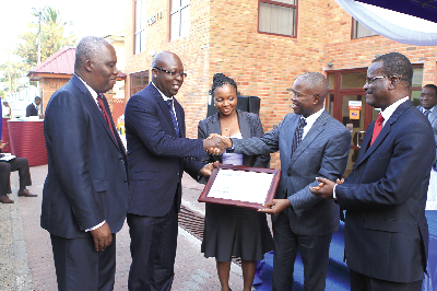 Mr Archie Hesse (2nd left), CEO of GhIPPS, presenting a certificate of membership of the “gh-link” to Mr Charles Cofie (2nd right), Board Chairman of First National.