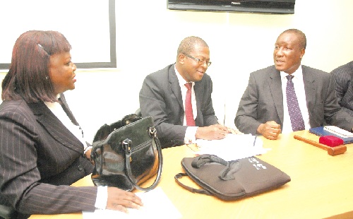 Nene Amegatcher (right), President of the Ghana Bar Association (GBA) chatting with Mr Peter Zwennes (middle), Vice-President and Mrs Yaa Gyakobo, Assistant Public Relations Officer, both of the GBA after the press conference. 