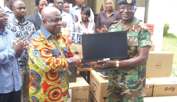 The Administrator of GIFEC, Mr Kofi Attor, presenting the items to the acting Chief Fire Officer, Brigadier General J.B.E. Guyiri. GNA