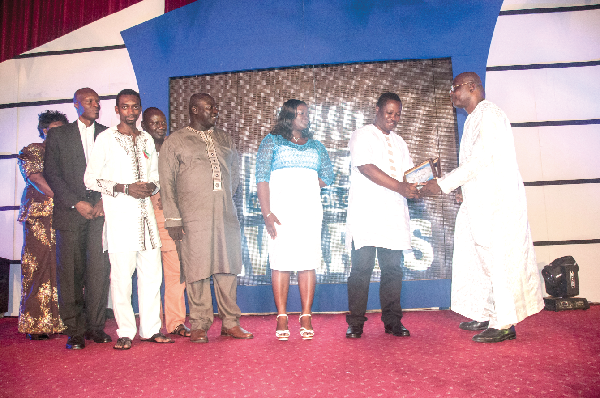  • Mr Hope Adusu (2nd left), Ag. Marketing Director  of GCGL, receiving a certificate and plaque for the CIMG Media Organisation of the Year Award from Mr Alex Baffoe.