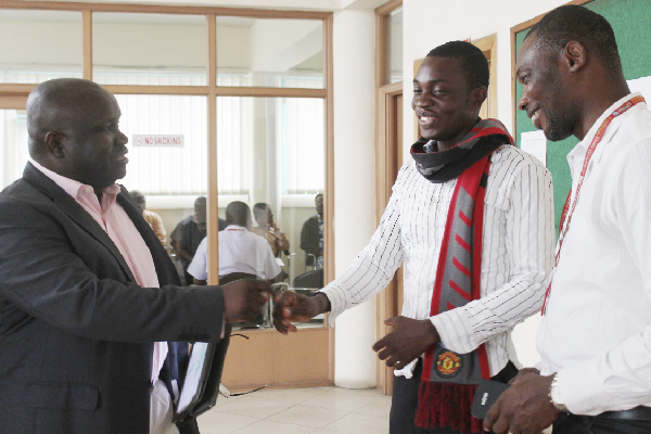 The MD of GCGL, Mr Ken Ashigbey (left), congratulating Mr Kportsu. Admiring the interaction is Mr Maurice Quansah, Assistant Editor of Graphic Sports. Picture: Edna Sarkodie