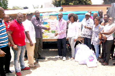 Rev. Fredrick Darkoh Asong (right), Resident Pastor ICGC Isreal Assembly, presenting the items to Mr Anyedei Nsiah (fourth left), Deputy Director Nursing and Service (MOH), during a donation at the Accra Psychiatric Hospital in Accra. Picture: Emmanuel Asamoah Addai 