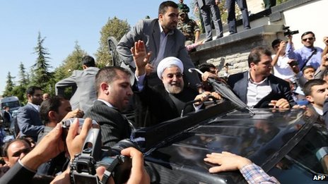 Both supporters and opponents met Mr Rouhani on his return to Tehran