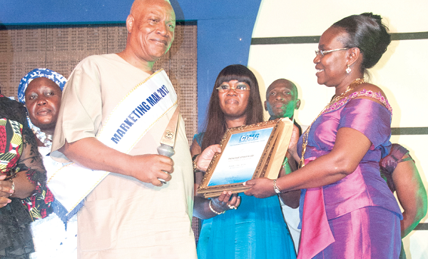 Prof. Joshua Alabi, Vice Chancellor of the University of Professional Studies, being presented with a certificate and plaque for winning the 2012 CIMG Marketing Man of the Year Award. Pictures: Douglas Anane-Frimpong