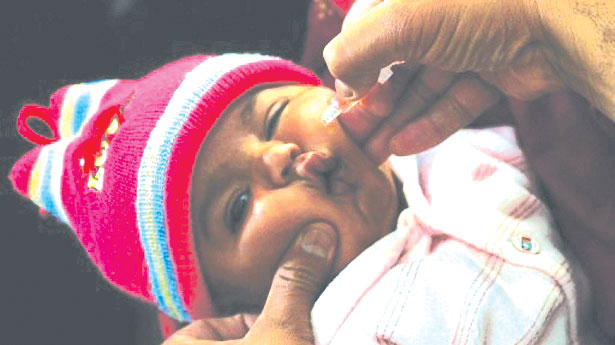 A child being administered with a polio vaccine