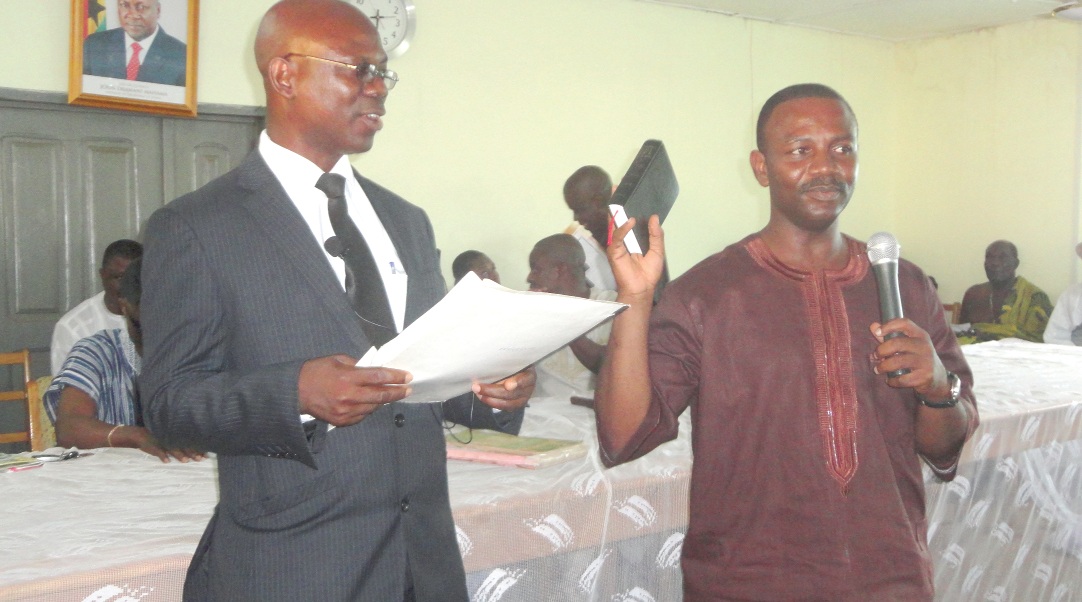 The Ketu North District Magistrate, His Worship Ernest Agbenya, administering the oath of secrecy to Mr Claver Kofi Lawson (holding the bible). 