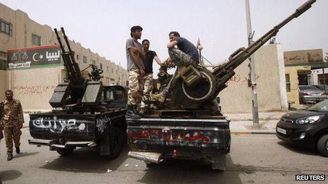 The justice minister and his staff left the building after it was surrounded by armed men, the BBC was told