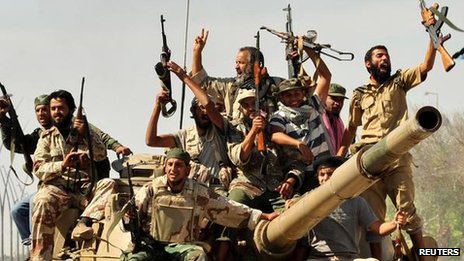Rebel fighters celebrate the fall of Sirte two years ago. Lawlessness has been rife across Libya since then