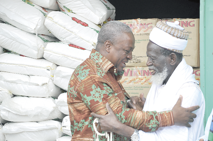 President Mahama in a hearty hug with Sheikh Osman Huhu Sharabutu after handing over some food items. Picture:  EBOW HANSON