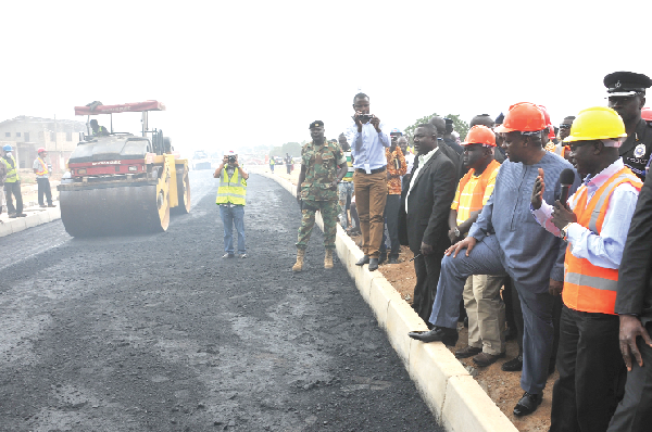  President Mahama (2nd right) taking a close look at work going on on the Awoshie-Pokuase road project