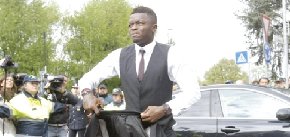 Time for serious business: Sulley Muntari arrives at his office, 4FK MotorSport, where cars are pimped for millionaires and super stars.