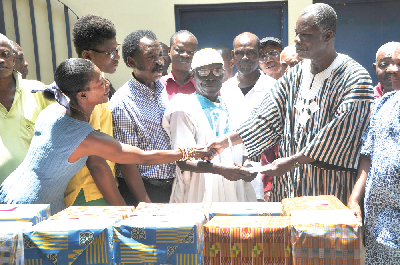 The La Akwashongtse, Nii Yemo Din II (right) thanking  Mrs Naomi Vogel Yemotsoo with a handshake.With them are some elders of La.