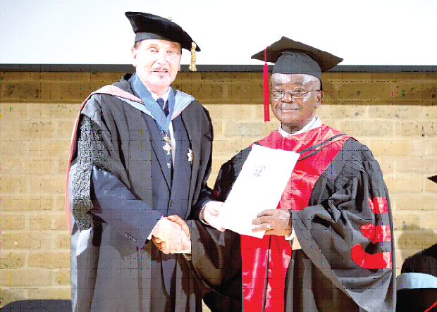 Dr Mirza (left) congratulating Dr Agyeman (right).