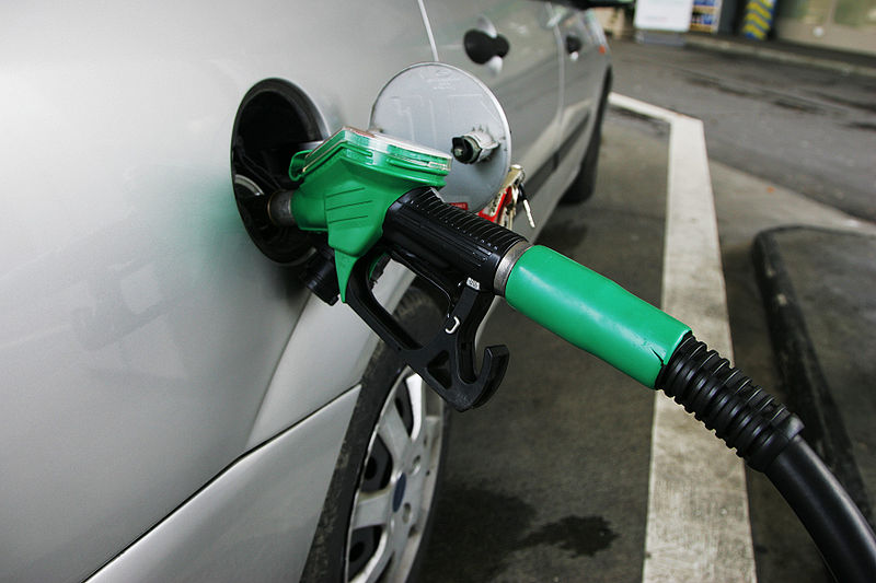 A fuel attendant in the process of filling a vehicle