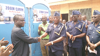 • The acting Communications Manager of Zoomlion, Mr Robert Coleman (left), presenting the mobile washrooms to the Accra Regional Police Commander, DCOP Christian Tetteh Yohuno (2nd from left), in Accra yesterday. Picture: ZAINABU ISSAH
