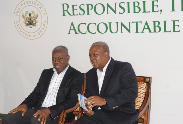 President John Mahama with a copy of the manual in his hand in a chat with Vice President Kwesi Amissah-Arthur