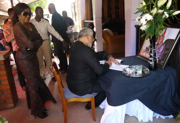 President and Mrs Rawlings signing the Book of Condolence opened for Prof Awoonor