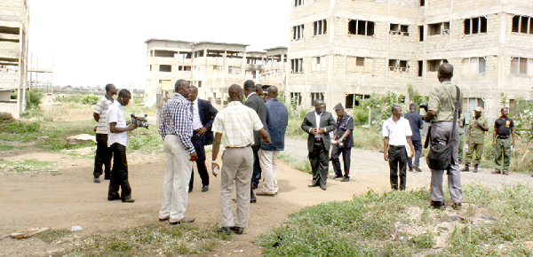 The Minister of Water Resources, Works and Housing, Alhaji Collins Dauda (3rd left) and his entourage inspecting some the uncompleted houses at Kpone in the Greater Accra region.