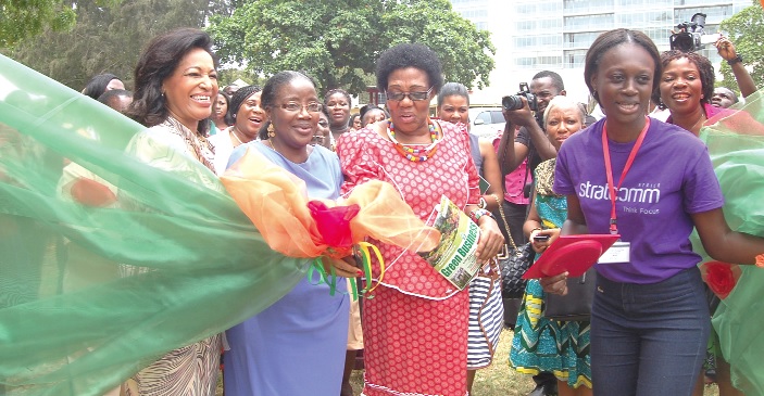 Mrs Matilda Amissah- Arthur (2nd left), Second Lady, cutting the ribbon to open the Flower and Garden Exhibition in Accra. She is  supported of Dr Juliet Tuakli (left), Chief Executive Officer, Child and Associates 