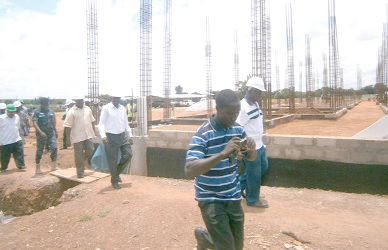 Dr Ephraim Nsoh (middle), UW Regional Minister, being led by Mr George Tetteh, Project Manager to inspect the project