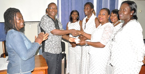• Mrs Emelia Arhin presenting the cheque to Dr Kwame Aveh. Looking on are executive members of the Women of Faith Ministry and  Mrs Marian Opoku (left), the treasurer at the Cancer Unit of the Korle Bu Teaching Hospital.