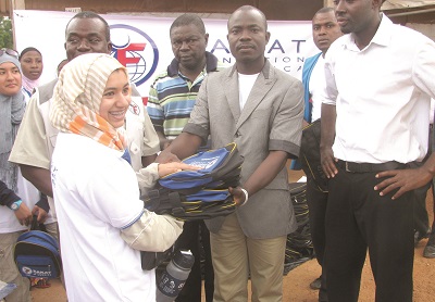 A member of the Zakat Foundation handing over some of the bags to the Educational Coordinator at the camp, Mr James Agbo. 