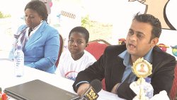 Master Kobena Asamoah Amoah (middle), flanked by his mother Anastasia Adoma Kenyah on the left and Mr Girish Gurbani on the right
