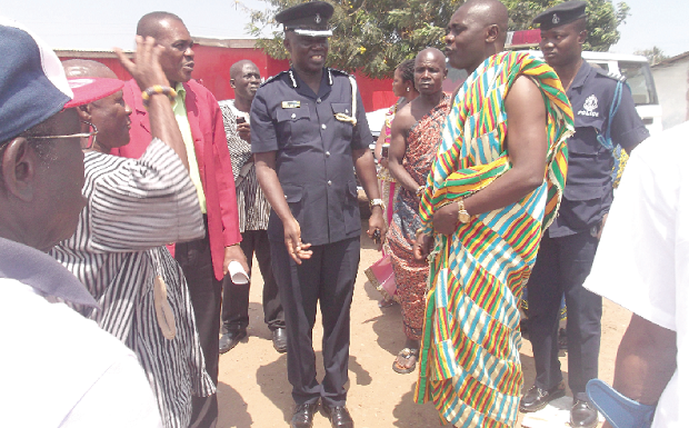 The Swedru Divisional Police Commander, Assistant Commissioner of Police, Nana Asomah (middle), chatting with Nana Apata Kofi (2nd right), Chief of Gomoa Pomadze, after the commander had inspected a piece of land earmarked for police station.