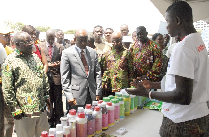  Mr Seth Terkper (2nd left), Minister of Finance and Economic Planning, being conducted round by Mr Antony Fofie (left), CEO of COCOBOD, to inspect some  cocoa products on exhibition at the Cocoa Festival. 