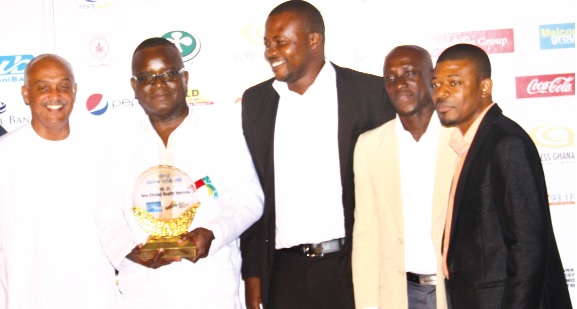 The CEO of New Crystal Health Service, Dr. Wisdom Amegbletor (with plaque) and other management staff. 