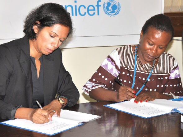Ms Charlotte Pierre (left), Team Leader of DfID, and Ms Susan Namondo Ngongi appending their signatures to the agreement documents.
