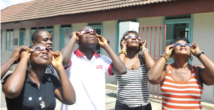 Some workers of the Graphic Communications Group Ltd. observing the eclipse.