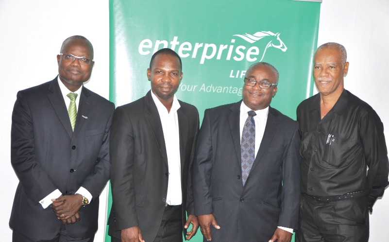 Mr C.C. Bruce Jnr (left), Executive Dirrector of Enterprise Life,  and Mr Pascal Kudiabor, the nominee with other officials after the signing ceremony.