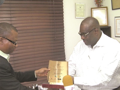  Amb. Dr Shelley U. Amos, (left) Chairman, Shelley’s Group, presenting the award to Engineer William Desbordes Albert Viala.