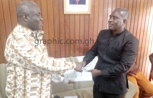 Eric Opoku (L), outgoing Brong Ahafo Regional Minister, handing over to Paul Evans Aidoo (R), incoming Brong Ahafo Regional Minister