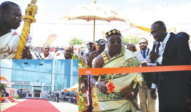 Rev. Oko Adjei (right) being assisted by Nii Odehe Kpakpa, Nungua Mantse to cut the tape to inaugurate the new branch. INSET: The new Fidelity Bank branch at Nungua. 