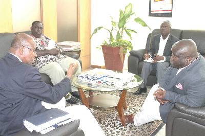 Mr Hubert D. Charles (left) in an interaction with Mr Kenneth Ashiegbey (right) during his visit to the Graphic offices in Accra. Those listening are Mr Kingsley Inkoom (2nd right), Deputy Editor, Daily Graphic, and Mr Albert Sam (2nd left), Public Affairs Manager, Graphic Communications Group Limited (GCGL). Picture: EDNA SARKODIE.