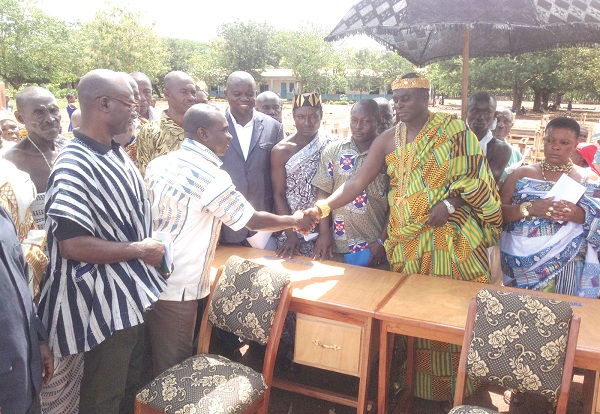 Mr Joseph  Appiah, acting Director of Plan Ghana, handing over the furniture to the acting President of the Suma Traditional Council, Nana Ansu Adane Kofrobour II (second right). 